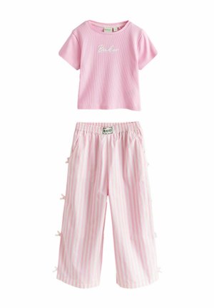 Ružový krátky rukáv s rebrovanou textúrou a logom "Baker" v kombinácii s ružovo-bielymi širokými nohavicami s vertikálnymi pruhmi, mašľami na bokoch a elastickým pásom.