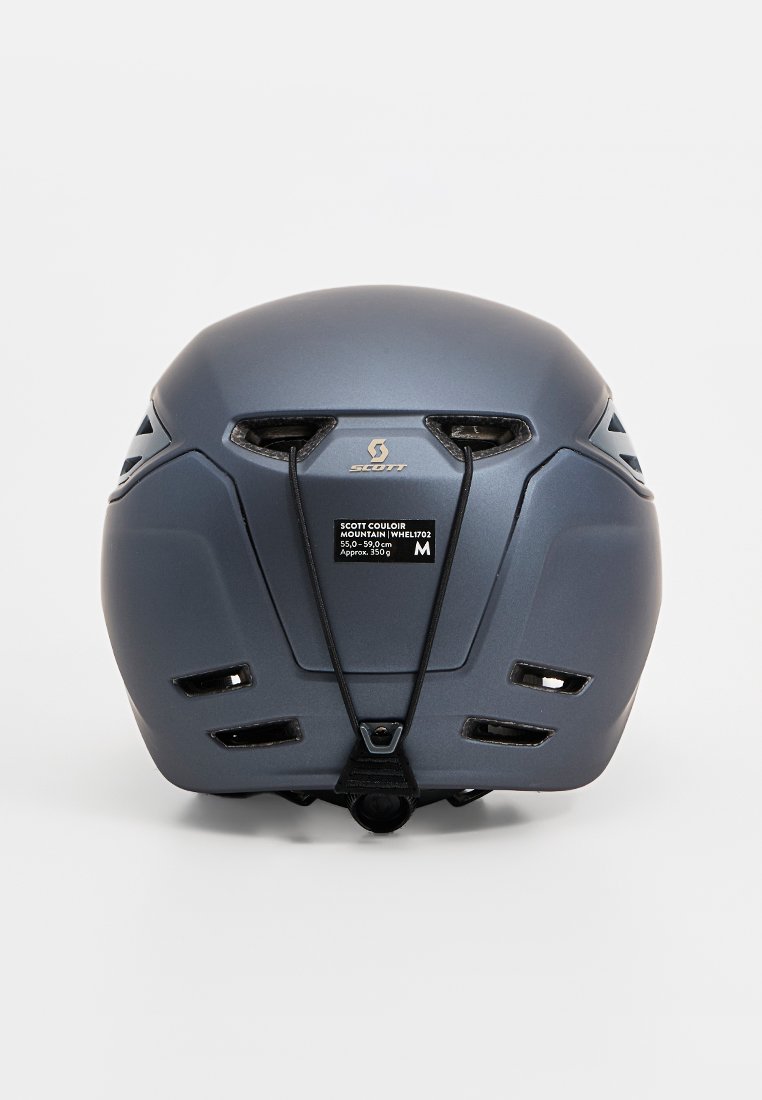 Hladký matný šedý horský helma s ventilačními otvory, nastavitelné popruhy a velikostní štítek (M, 55,0-59,0 cm) na zadní straně.
