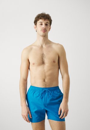 Shorts da bagno blu realizzati in materiale leggero con vita elastica e cordoncino. Design semplice, lunghezza sopra il ginocchio.