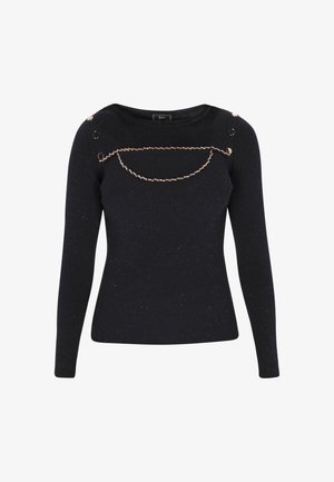 Laivastonsininen ribbitekkimme pitkilla hihoilla, jossa on kultasävytteiset yksityiskohdat ja koristeellinen ketju rinnan alueella.