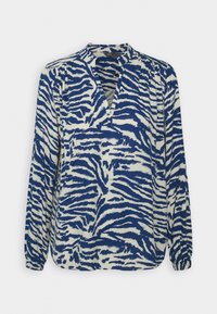 Blaue und weiße gemusterte Bluse mit langen Ärmeln, V-Ausschnitt und lässiger Passform; verfügt über ein Zebrastreifen-Design auf leichtem Stoff.
