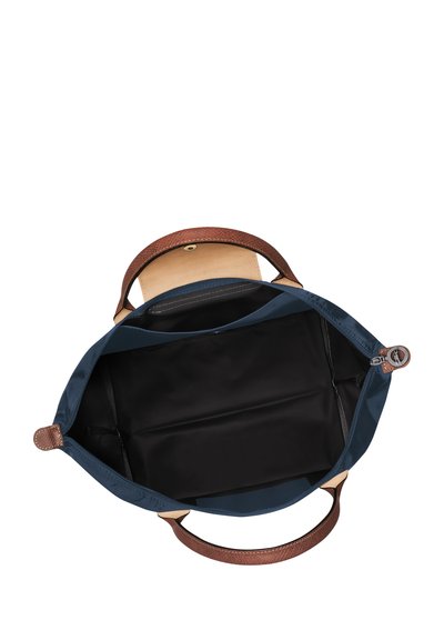 Blue fabric tote bag with brown textured leather handles, open view showing a black interior, featuring a flat base and no additional pockets.