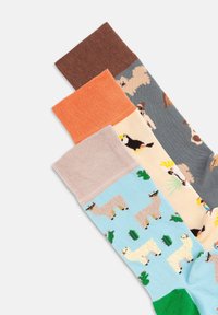 Farvede sokker i forskellige nuancer: brun, orange, beige og blå. Detaljer inkluderer dyremønstre (lamaer, hunde og fugle) samt ensfarvede bånd.