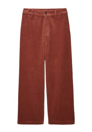 Pantalons larges en velours côtelé rouge rouille, présentant un motif texturé, fermeture à bouton sur le devant et poches classiques.