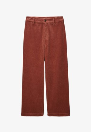 Pantalons larges en velours côtelé rouge rouille, présentant un motif texturé, fermeture à bouton sur le devant et poches classiques.