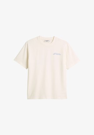 T-shirt en coton crème à manches courtes, col rond, avec un texte bleu sur le côté gauche de la poitrine indiquant "feeling good MÁRCO POLO DENIM."