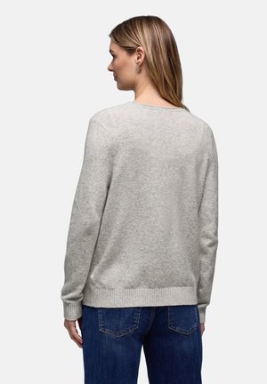 Vaaleanharmaa poolopaita pyöreällä pääntiellä, resorilla varustetut hihat ja helma, yhdistetty tummansinisiin farkkuihin. Pehmeä materiaali, yksinkertainen muotoilu ja rento istuvuus.