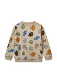 Sweat-shirt beige pour enfants avec des illustrations de monstres colorés et ludiques en bleu, marron, gris et noir, présentant diverses expressions et formes.
