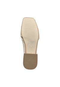 Beige leather shoe sole with a textured, ridged surface. Markings include brand name and size 36. Rounded shape, minimalistic design.