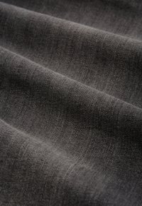 Textured gray fabric displays a slight sheen with visible diagonal weaving patterns, creating a smooth, soft surface.