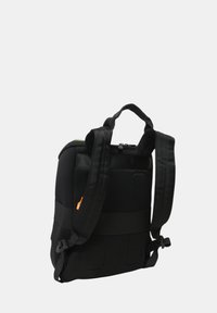 Zaino nero con spallacci imbottiti, pannello posteriore in rete, maniglia superiore e un'etichetta arancione sul lato, mostrato su uno sfondo neutro.