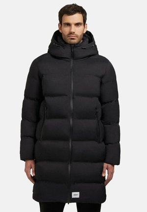 Black puffer coat with a zip closure, hood, and side pockets. Features a quilted design with a puffy, insulated texture for warmth.