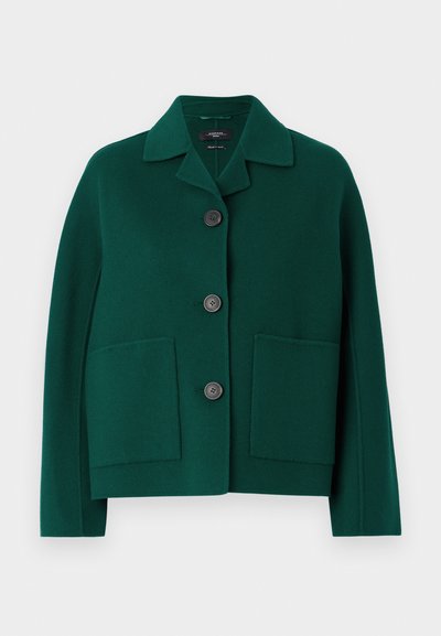 Žalias vilnos mišinio švarkas su apykakle, priekyje užsegamas mygtukais, turi dvi dideles kišenes. Yra laisvas sluoksnis ir lygus paviršius.