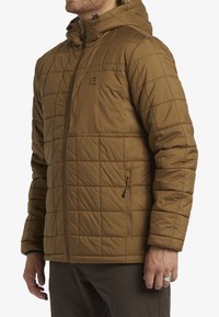Brown insulated jacket with a quilted design, attached hood, zippered front, and side pockets. Features smooth texture and a modern fit.