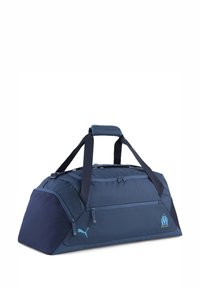 Sac de sport en tissu bleu foncé avec deux compartiments zippés, poignées assorties et accents de logo brodés en bleu clair.