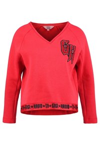 Rode sweatshirt met V-hals, lange raglanmouwen, voorzien van een zwart geborduurd logo en een zwarte band met tekst en sterren aan de zoom.