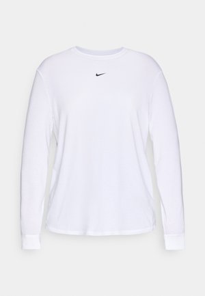 Balta ilga rankovė T-marškiniai, pagaminti iš minkštos medvilnės, su apvalia iškirpte ir mažuoju juodu Nike swoosh logotipu ant krūtinės.