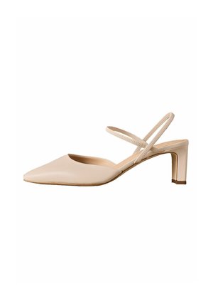 Beige pointed-toe slingback shoe with low block heel and double elastic straps across the ankle.