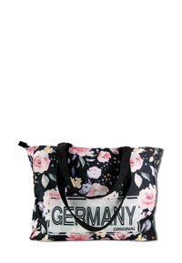 Black fabric tote bag with pink floral pattern, black handles, and a white "GERMANY ORIGINAL" text label on the front.