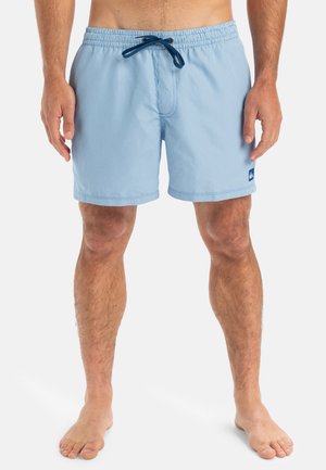 Light blue swim shorts with vertical white stripes, elastic waistband, drawstring closure, side pockets, and a small logo on the left leg.