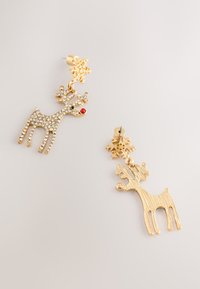 Gold reindeer-shaped earrings with crystal accents, red nose, and snowflake detail. Textured and smooth finishes on individual pieces.