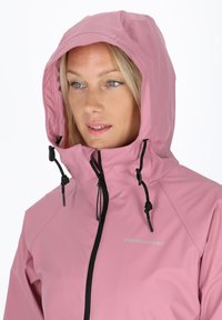 Pink waterproof jacket with a hood, featuring black drawstrings, a full zipper front, and logo placement on the left chest area.