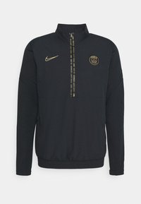 Sort langærmet Paris Saint-Germain quarter-zip jakke med guld Nike-logo og PSG-emblem, elastisk kant og mærkezipe.