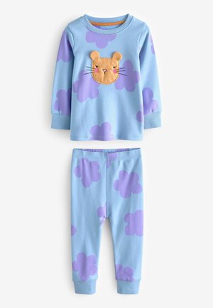 Heleda sinine pidžaama komplekt, millel on pikad varrukad ja püksid, ning millel on beez lõvi näo aplikaatsioon ja lilla pilve muster mõlemal osal.