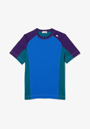T-shirt met korte mouwen in kleurvlakken van blauw, paars en groen met contrasterende stiksels en Lacoste-logo linksboven. Gemaakt van een katoenmengsel.