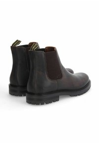 Bottes Chelsea en cuir marron avec panneaux latéraux en élasthanne, dos texturé, semelles en caoutchouc rainurées et tirettes dotées d'étiquettes jaunes.