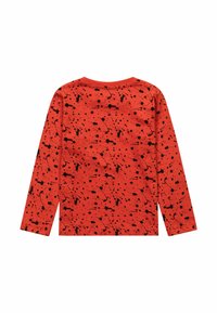 Red long-sleeve shirt featuring a black splatter pattern, round neck, and soft texture. The design covers the entire back of the shirt.