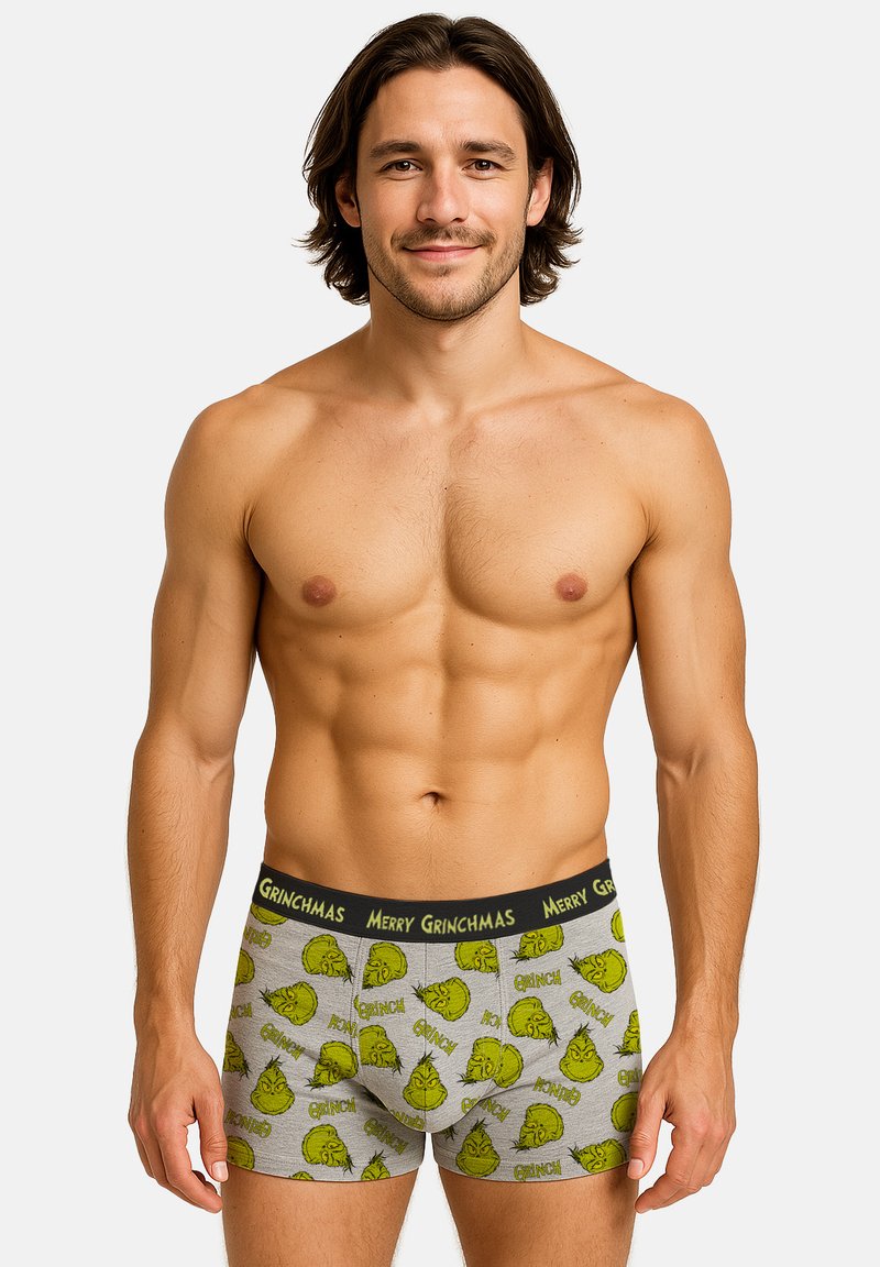 Boxer da uomo grigi con motivo del Grinch verde, elastico nero in vita con testo "MERRY GRINCHMAS" e design aderente.