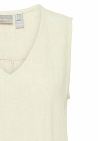 Licht beige mouwloze top met een diepe V-hals. Gemaakt van een geweven, linnen-achtige stof. Heeft een geplooid detail aan de achterkant.