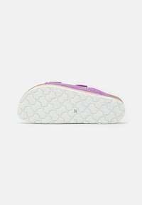 Purple suede shoe with a textured white rubber sole, featuring a cork base and embossed size marking on the underside.
