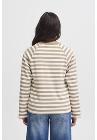 Haut rayé pour femme en beige et marron, avec des manches longues, un design raglan et un matériau en coton doux. Équipé d'un col rond et d'une coupe décontractée.