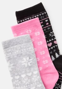 Three pairs of socks: gray with snowflake design, pink with small patterns, and black with various hearts and trees. Soft knit texture.