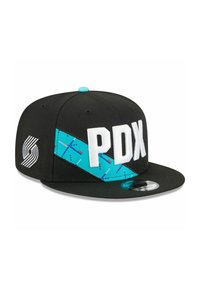 Black snapback cap features white "PDX" lettering, a turquoise patterned band, and an emblem with striped design on the side.