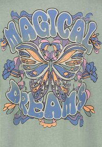 Grafisches T-Shirt mit einem verblassten grünen Hintergrund, das ein Schmetterlingsdesign in Orange und Blau zeigt, umgeben von blumigen Akzenten und fettem Text.