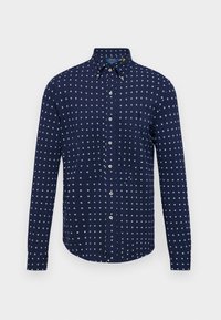 Námořnická modrá košile na knoflíky s geometrickým bílým vzorem, přiléhavý střih, dlouhé rukávy a límec na knoflíky.