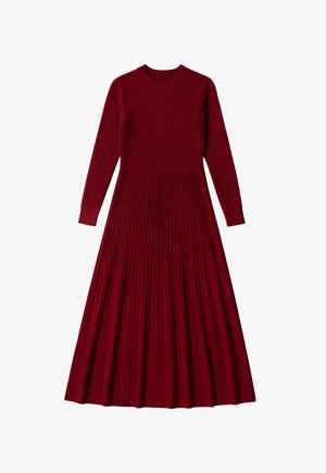 Red knit dress with long sleeves, ribbed texture, and a fitted waist that flows into a pleated A-line skirt. Round neckline.
