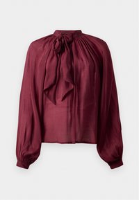 Bluză bordeaux cu guler înalt, mâneci lungi tip puff și detaliu cu fundă la guler. Fabricată dintr-un material neted și ușor.