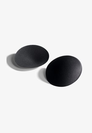 Czarne, owalne obiekty o matowym wykończeniu i gładkiej fakturze, z subtelnymi różnicami w głębokości powierzchni.