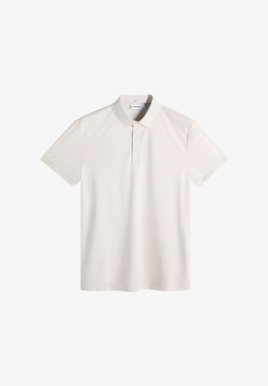 Lichtbeige polo met korte mouwen, knoopsluiting aan de kraag en subtiele branding op de linker mouw en het binnenlabel van de kraag.