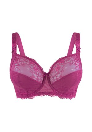 Soutien-gorge en dentelle fuchsia avec des panneaux en mesh transparent, support par armature, bords festonnés et nœuds décoratifs sur les bretelles. Motif floral en dentelle détaillé.
