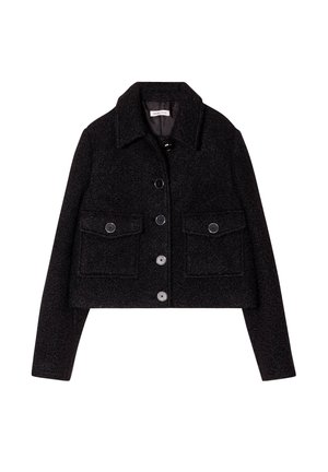 Black cropped jacket made of textured fabric, featuring a classic collar, front pockets, and a button-up closure with dark buttons.