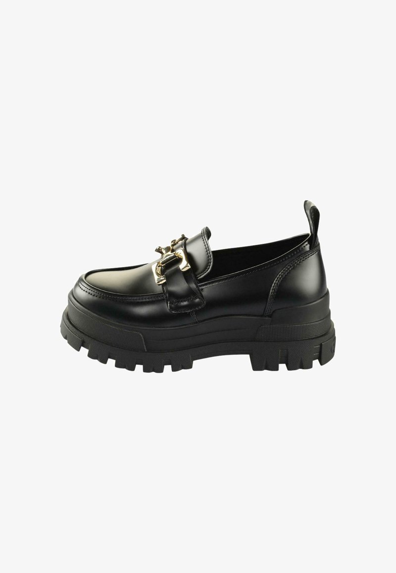 Black leather slip-on shoes with a chunky sole, decorative gold hardware on the front, and a textured grip outsole.