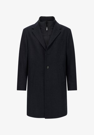 Manteau en laine bleu marine foncé avec une coupe structurée, des revers crantés, deux poches avant, une fermeture par un bouton unique et une doublure intérieure matelassée.