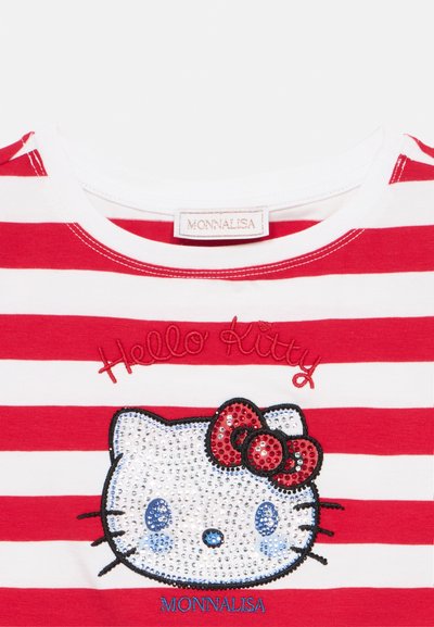 Chemise rayée rouge et blanche avec visage de Hello Kitty orné de strass et nœud rouge, étiquettes brodées "Hello Kitty" et "Monnalisa".
