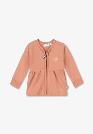 Cardigan rose clair avec fermeture éclair, poignets côtelés et taille froncée. Présente une broderie simple de feuille sur le côté gauche.