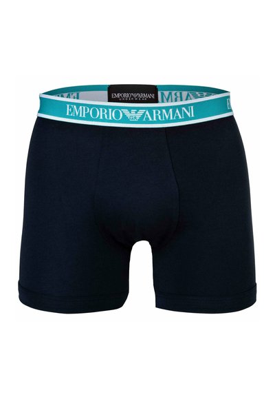 Temno mornarsko modri bombažni bokserica z turkiznim elastičnim pasom, ki nosi logotip "Emporio Armani". Gladka tekstura, prilegajoča zasnova.